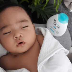 sleeping baby wrapped in a white blanket