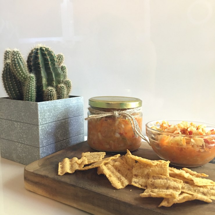 A jar of Curtido with chips