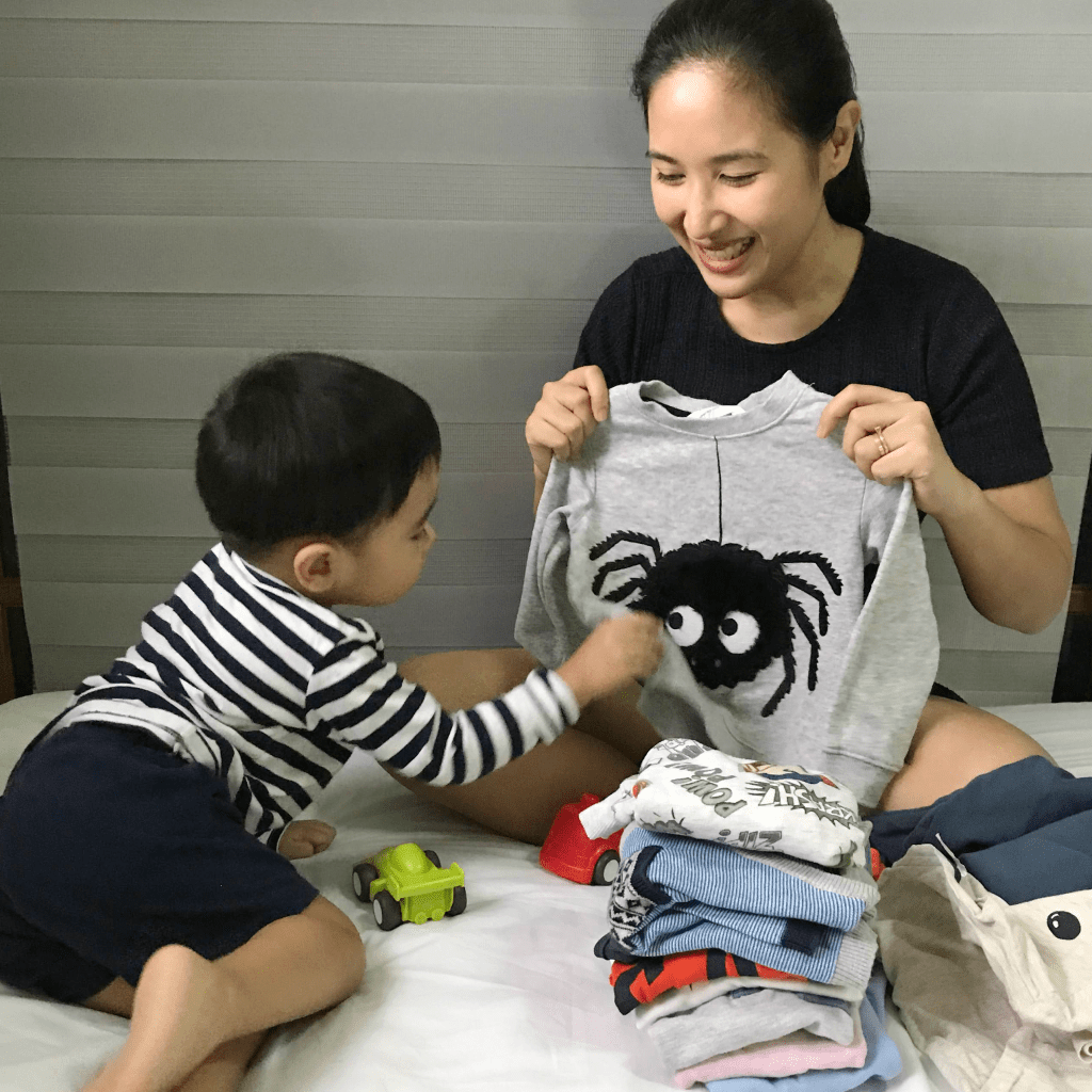Montessori way: mom teaches a toddler how to fold clothes