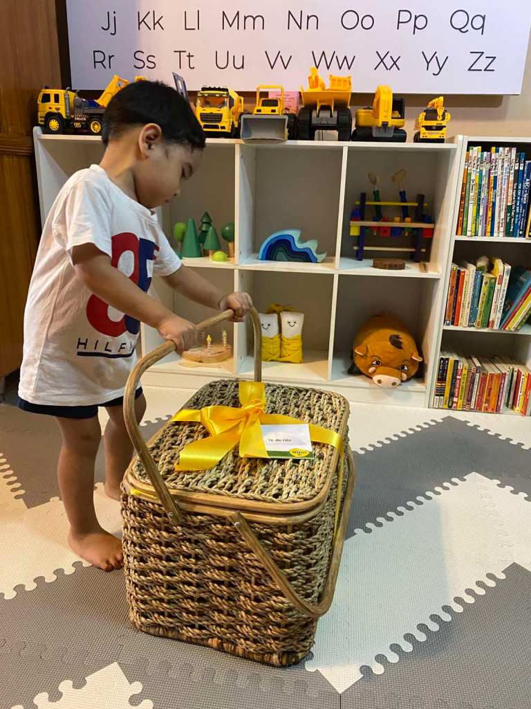 Toddler setting up a picnic basket