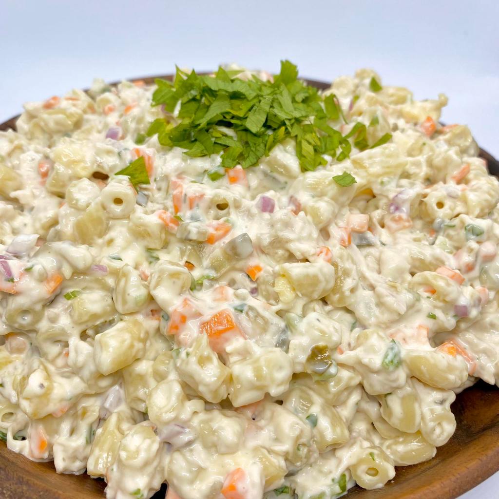 A mound of macaroni salad topped with chopped celery