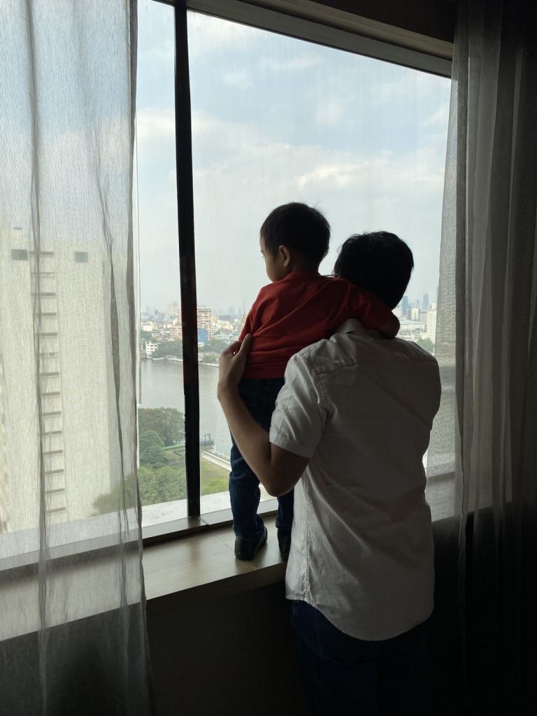 Father and son looking out the window