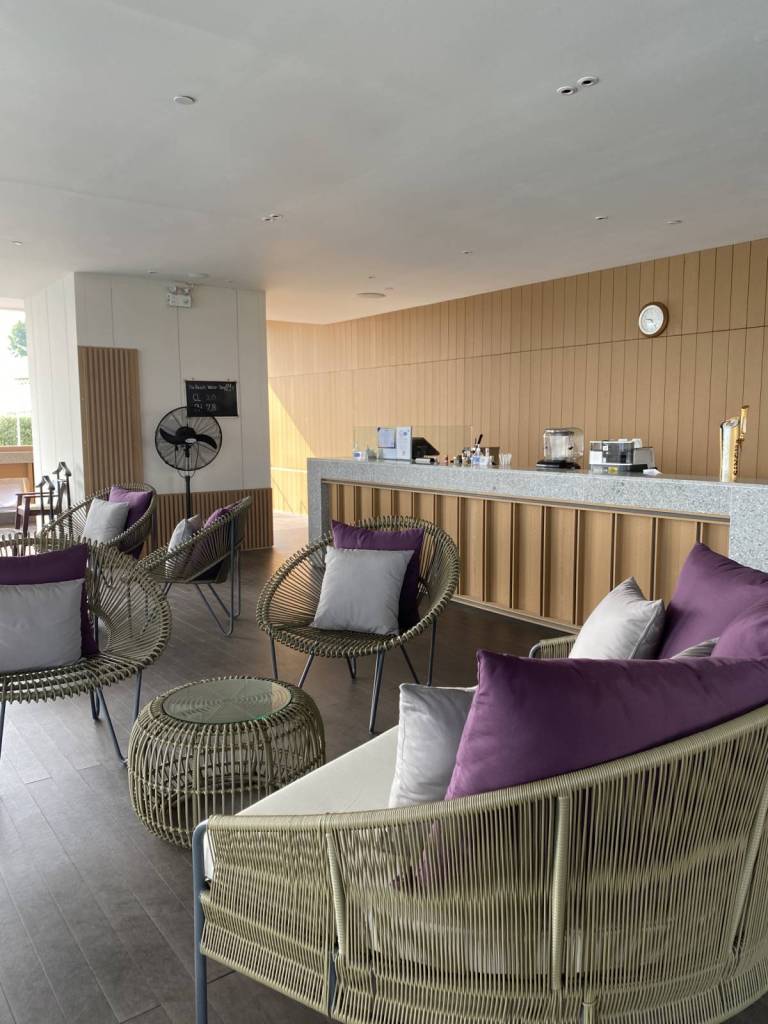 Wooden chairs with accent pillows at the pool side of Millenium Hilton Bangkok