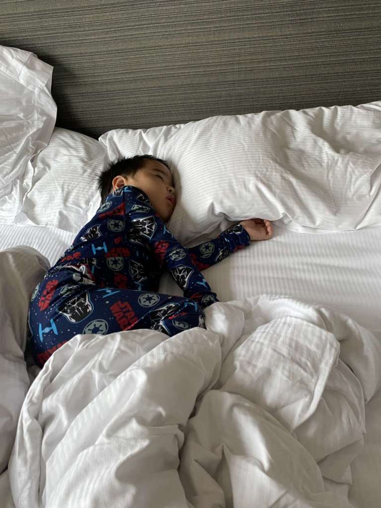 Little boy sleeping soundly at Millenium Hilton Bangkok