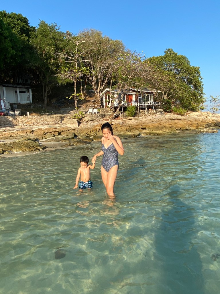 Mom and son walking on the beach