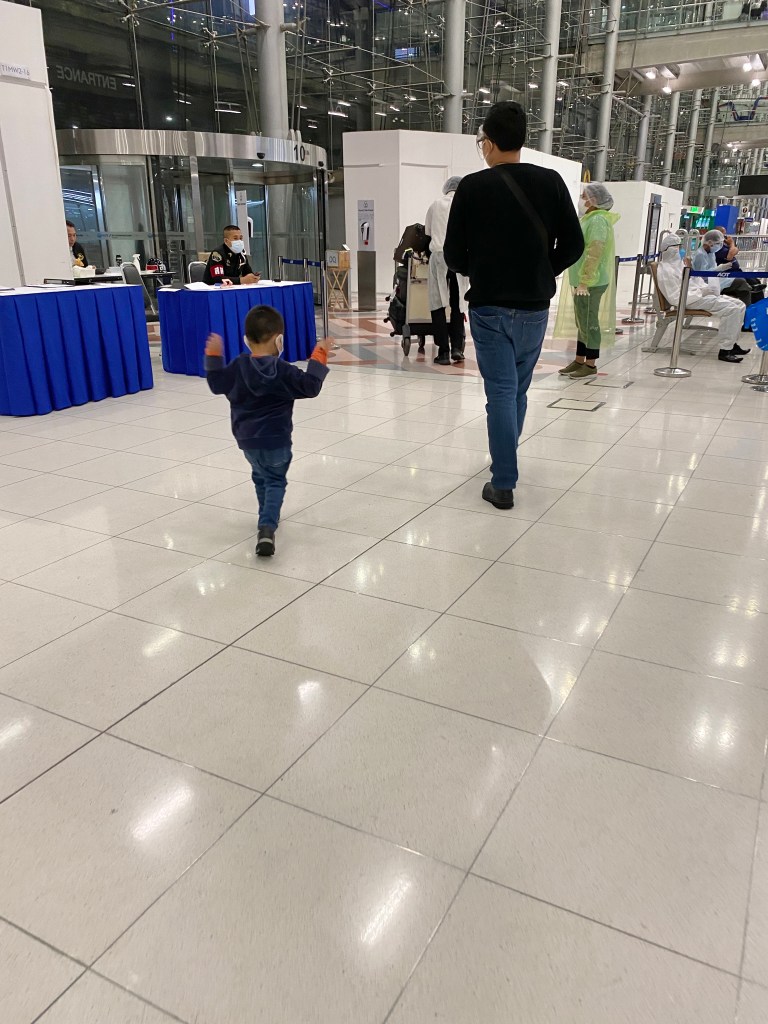 Father and son exiting the airport