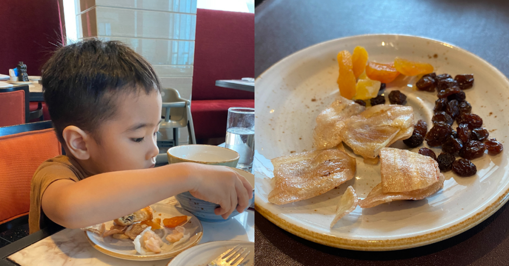 Little boy eating at a breakfast buffet
