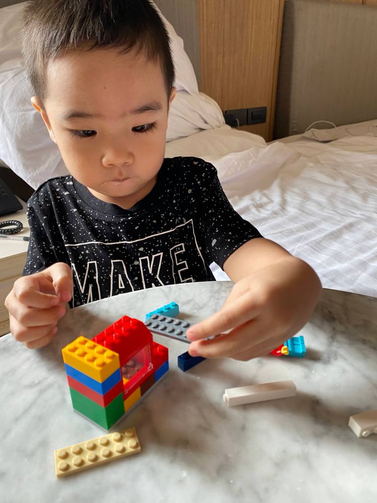 Little boy playing with his first lego set
