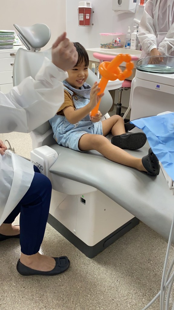 Little boy gets a balloon as a reward after his dental check up