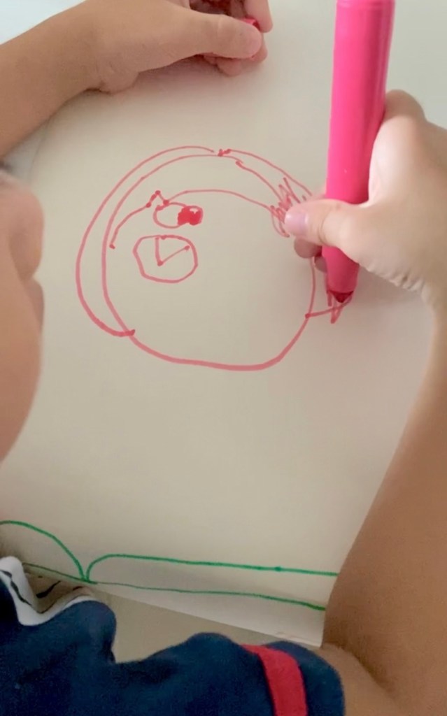 Little boy drawing an octopus