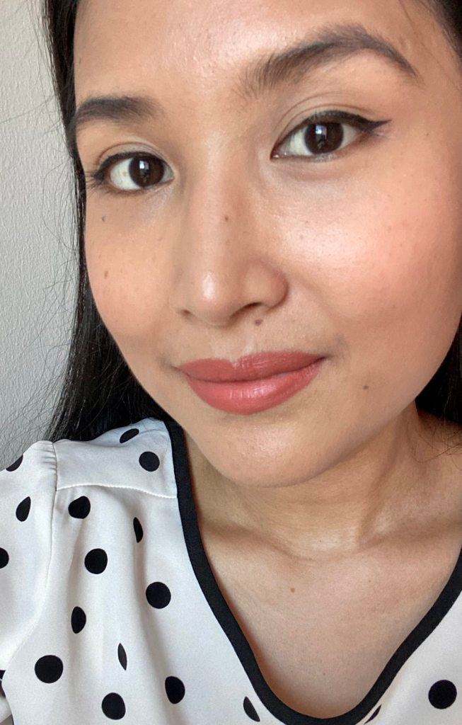 Woman wearing coral-tinted lipstick