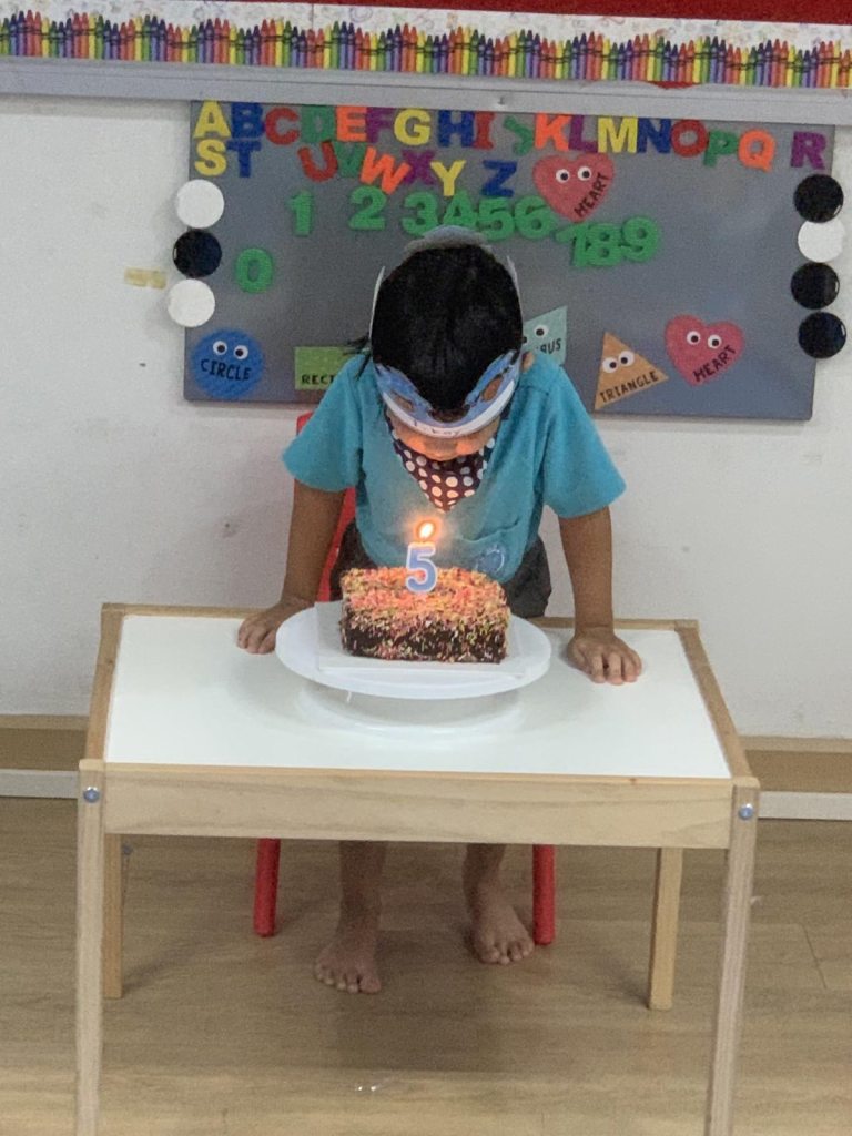 Little boy blowing a birthday candle