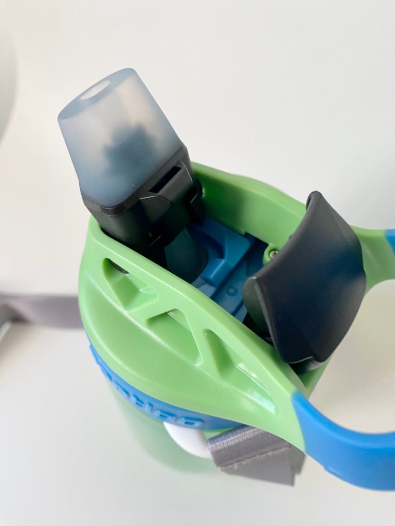 Green and blue water bottle with a spout cover