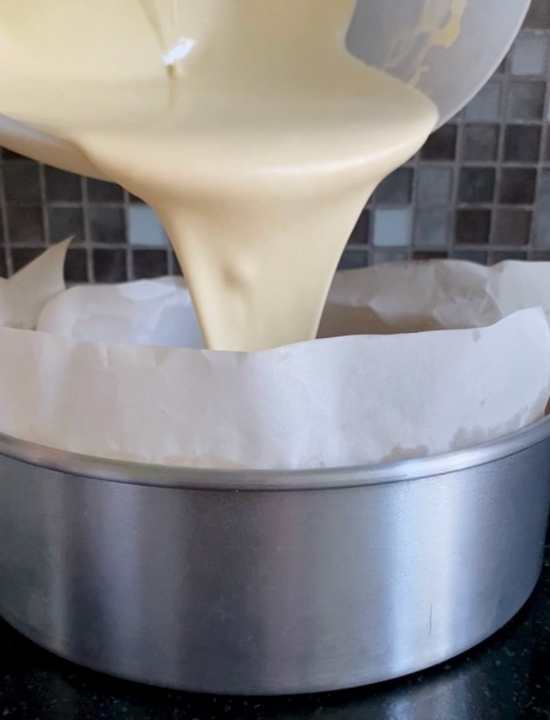 pouring cheesecake filling