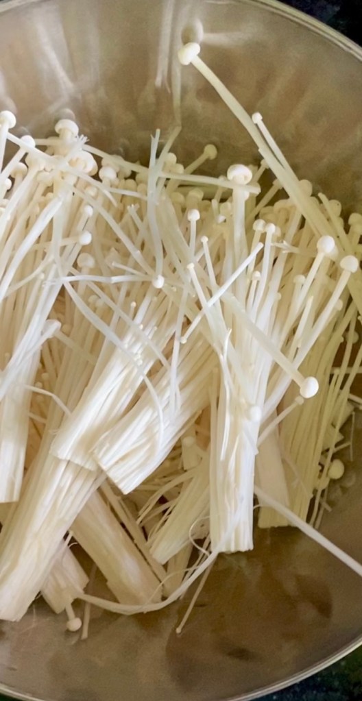 A bowl of prepared enoki mushrooms