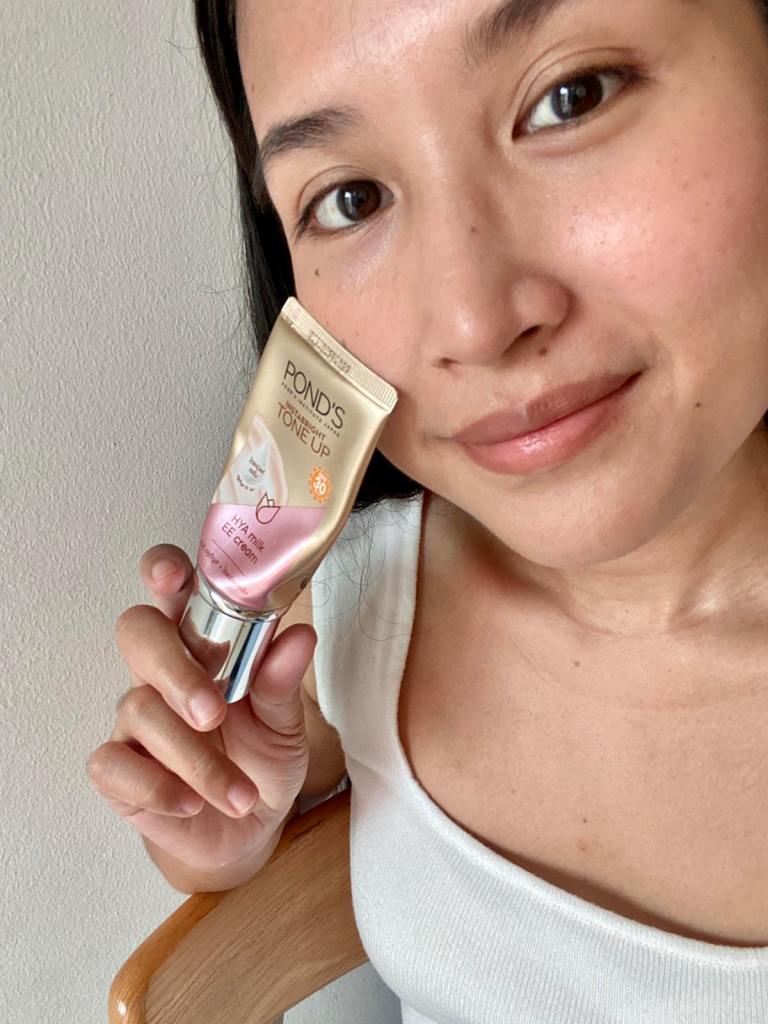 Smiling woman showing her make up