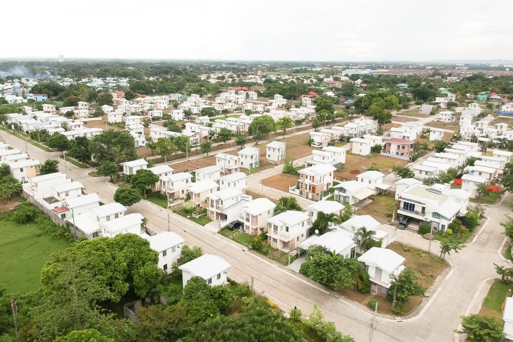 A subdivision with white houses