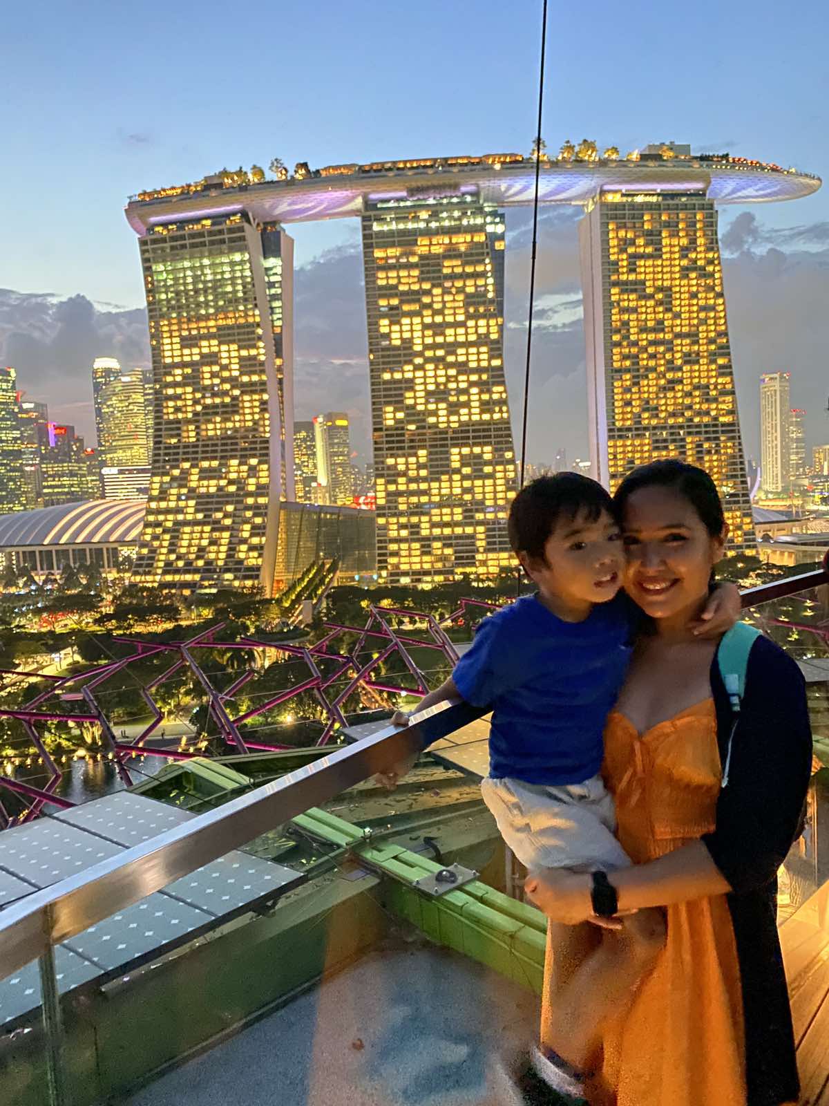 Mom and son smiling with the Marina Bay Sands as background