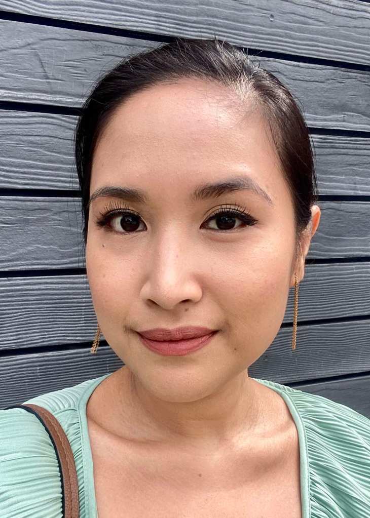 Smiling woman in full makeup