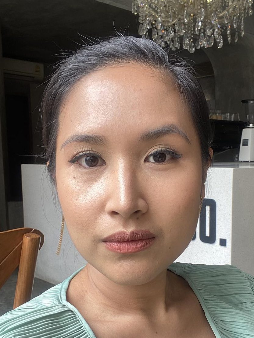 smiling woman in full makeup
