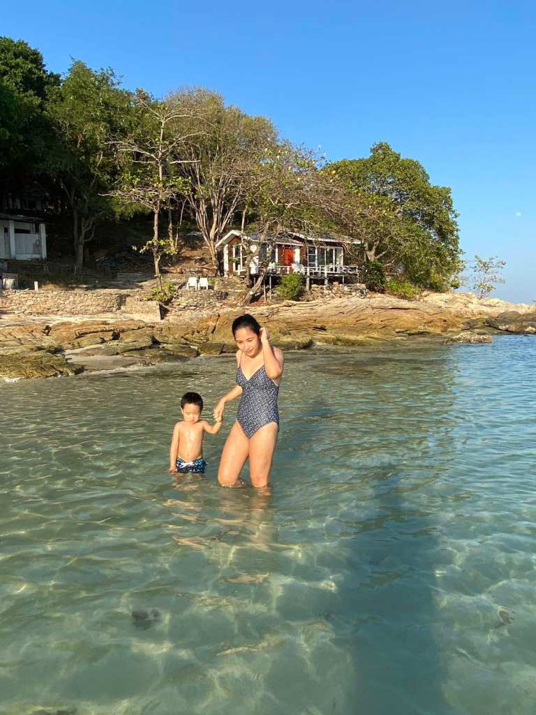 Mom and son walking at the beach