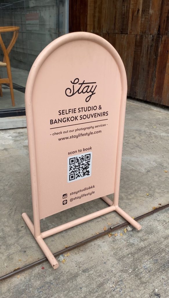 a pink signage for a selfie studio