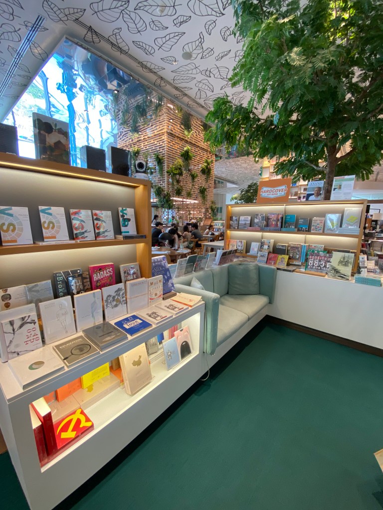Shelves of books for sale with a couch for reading