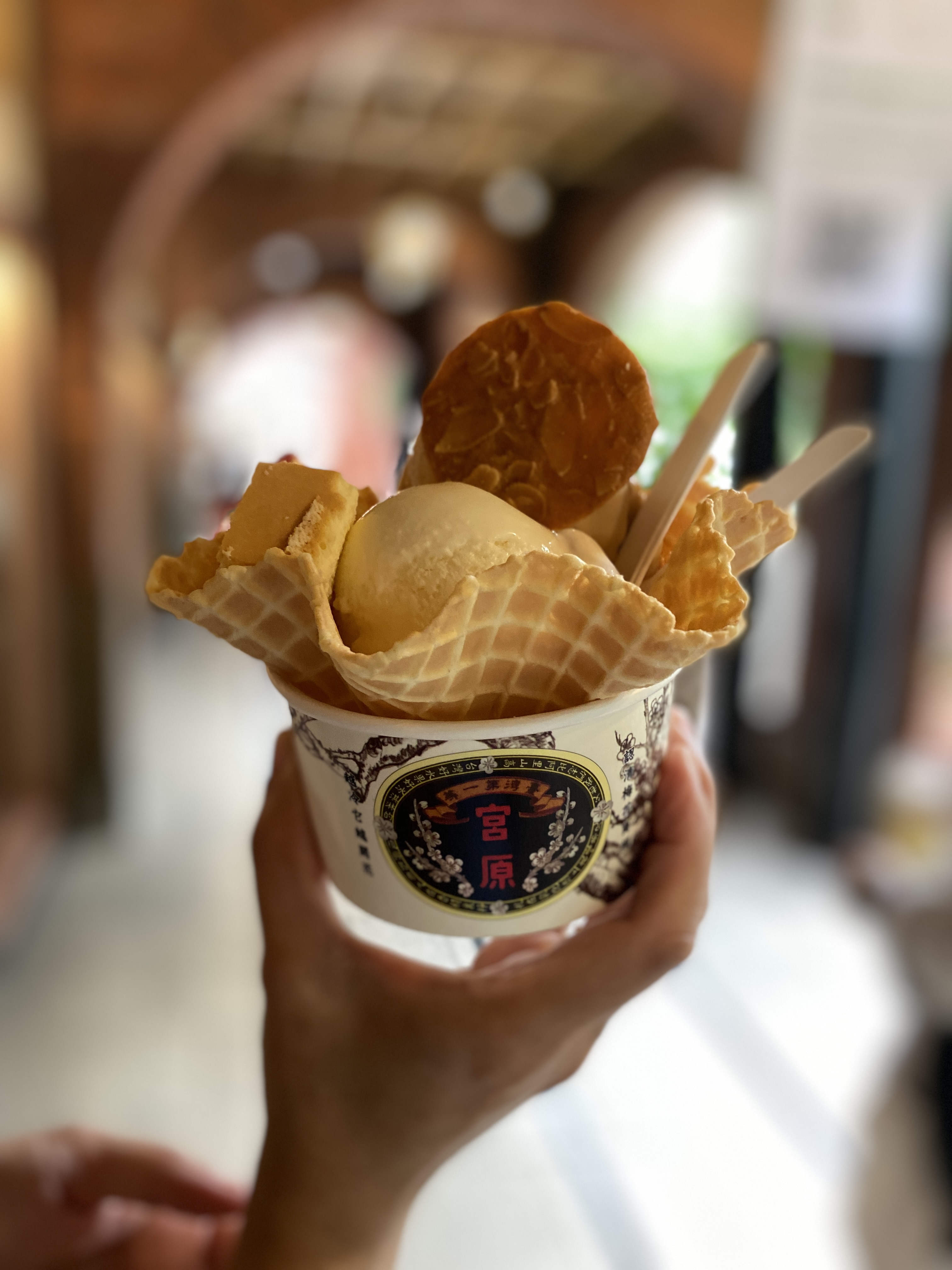 Holding a cup of Miyahara ice cream on a crisp waffle cone topped with an almond brittle